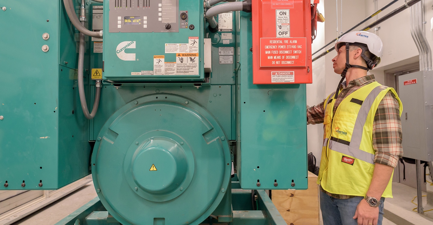 Veritas employee examining large machinery